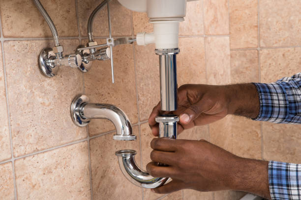 Close-up Of Male Plumber's Hand Fixing Sink In Bathroom